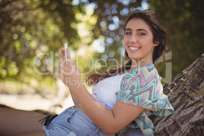 Portrait of smiling woman using smart phone