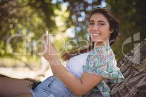 Portrait of smiling woman using smart phone