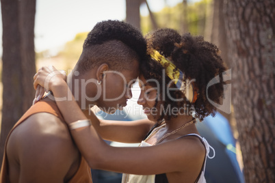 Close up of romantic couple standing against tent