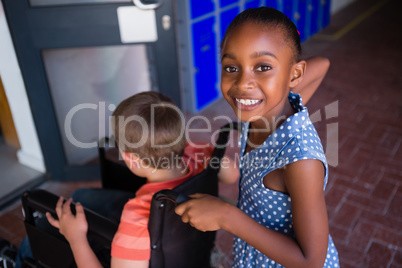 Portrait of smiling girl with classmate at school
