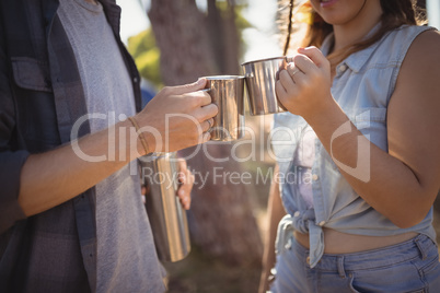 Midsection of couple drinking coffee