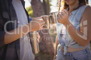 Midsection of couple drinking coffee