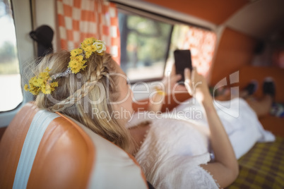 Woman using phone in van