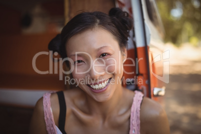 Portrait of smiling woman sitting in mini van