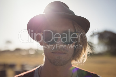 Close up portrait of handsome man standing against clear sky