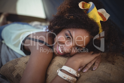 Portrait of smiling woman lying in tent