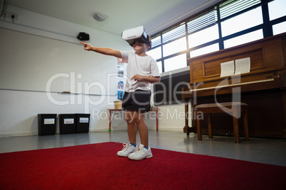 Boy wearing virtual reality simulator dancing at home