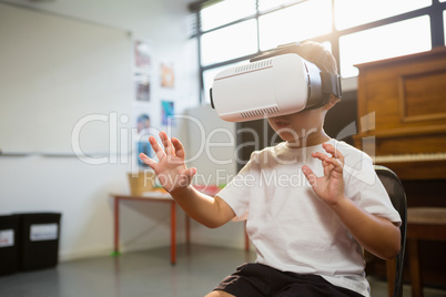 Happy boy wearing virtual reality simulator while standing at home