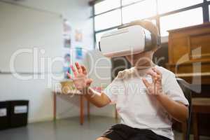 Happy boy wearing virtual reality simulator while standing at home
