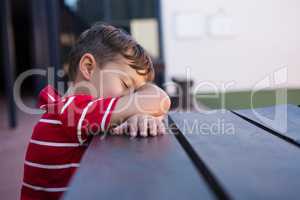 Close up of boy sleeping on table
