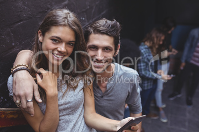 Portrait of couple holding mobile phone