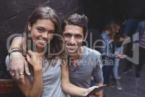 Portrait of couple holding mobile phone