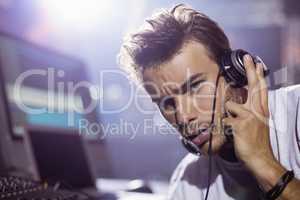 Portrait of young male dj with headphones at nightclub