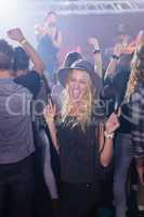 Cheerful woman enjoying in nightclub