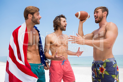 Shirtless male friends talking while standing against clear sky