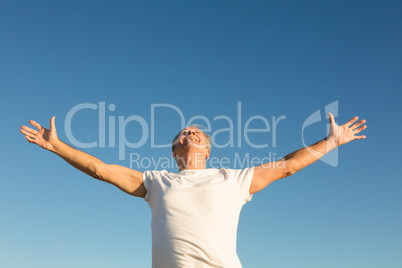 Low angle view of man with arms outstretched