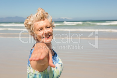 Portrait of smiling senior  woman standing against clear sky