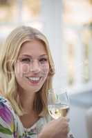 Portrait of smiling woman having wine during lunch