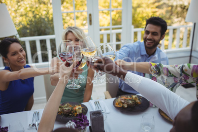 Friends toasting wine glasses in restaurant