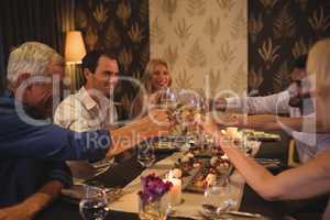Friends toasting champagne glasses in restaurant