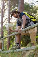 Man reading the map near the wooden fence