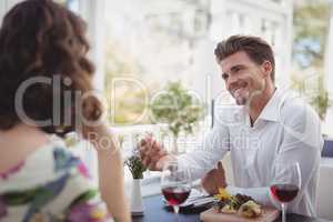 Handsome man offering engagement ring to woman