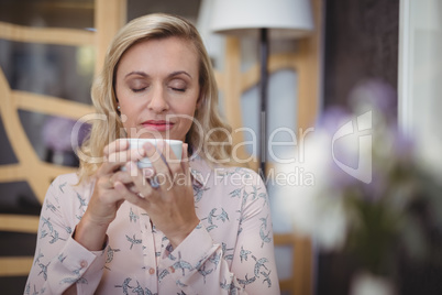 Beautiful woman smelling black coffee