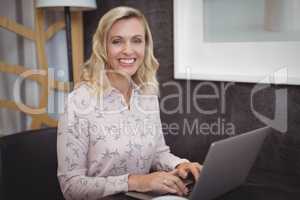 Portrait of beautiful woman using laptop