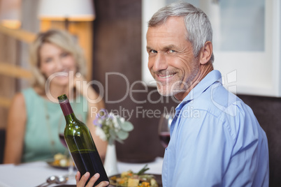 Mature couple having meal and red wine