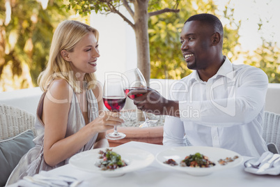 Romantic couple toasting their wine glasses