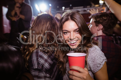 Portrait of happy woman enjoying music festival