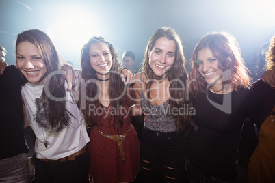 Portrait of young happy female friends at nightclub