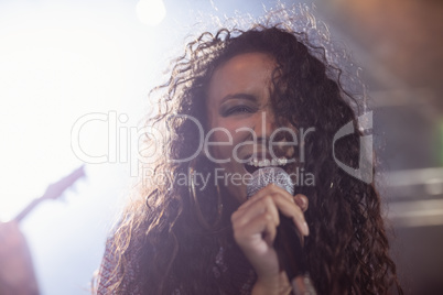 Young female singer performing in nightclub