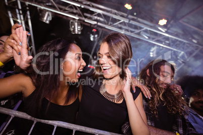 Cheerful female friends enjoying at nightclub