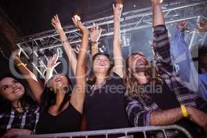 Low angle view of fans enjoying at music festival