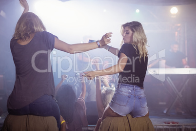 Female friends dancing at nightclub