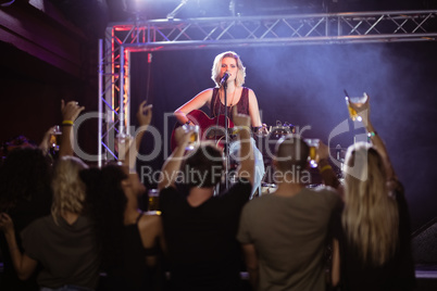 Female performer singing during music event