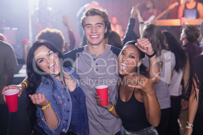 Portrait of cheerful friends at nightclub