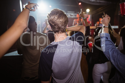 People enjoying concert in nightclub