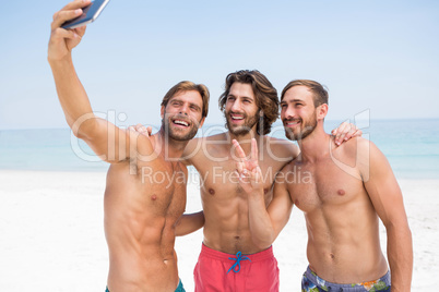 Smiling male friends taking selfie