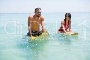 Couple on surfboard in sea