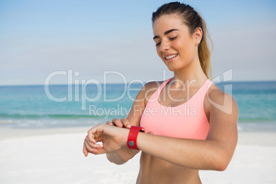 Smiling woman looking at wristwatch