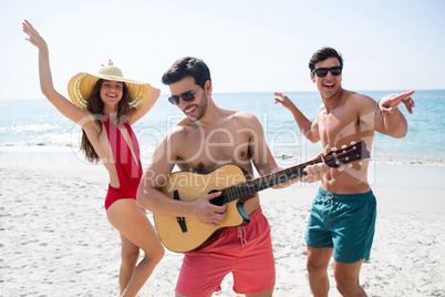Happy young friends enjoying at beach