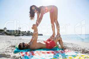 Portrait of playful couple enjoying at beach