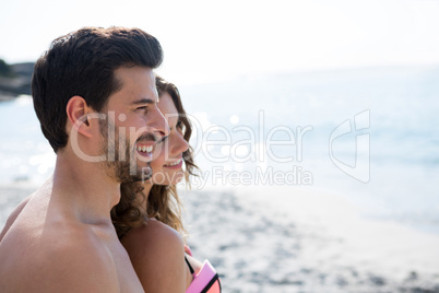 Thoughtful young couple standing at beach
