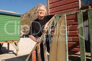 Man looking away while standing at beach hut