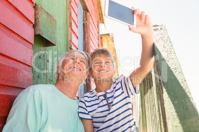 Happy boy with grandfather taking selfie
