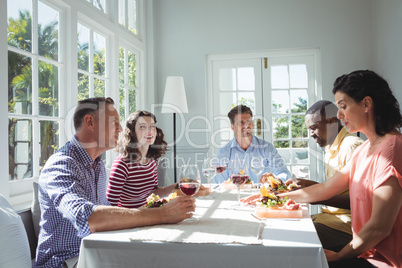 Group of friends interacting while having meal