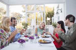 Group of friends interacting with each other while having meal together