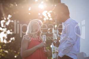 Affectionate couple having champagne in balcony